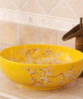 Top Tier Yellow Floral Ceramic Vessel Sink For Bathroom Countertop Featuring Handmade Artistry Slick Craftsmanship No Fuss Install With Center Drain And Fresh Vibes To Level Up Your Bathroom, round, glossy, floral design.