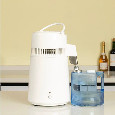 Built Tough Water Distiller Machine Packs 750 Watt Heating Coil next to a blue four-liter water catch bucket.