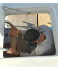 Man using a marine gas spring strut for heavy shop jobs; focus on grip and support, 34 inch and rustproof marine steel.