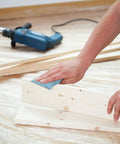 Auto Body Sanding Kit With 28 Pcs Wet Dry Sandpaper Pack used on wooden board, power drill in background