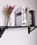 Heavy Duty 16 Inch Shelf Brackets With Lip Tough Industrial Wall Mount Metal Storage Brackets For Indoor Outdoor Use Rust Resistant Includes Screws 2 Pack Black supporting a wooden shelf with books and vase.