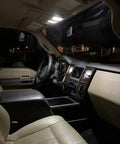 32 Piece LED Car Interior Light Kit With T10 Wedge And Festoon Bulbs For Dome Map Door Trunk Courtesy Lights Bright White Replacement Kit Includes 29mm 31mm And 41mm Sizes shown in car interior with bright illumination from dome light.