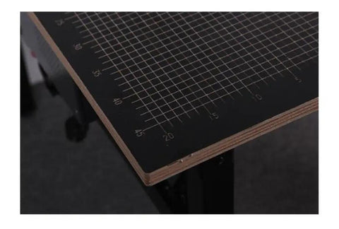 Close-up of Pro Grade Desktop Hot Wire Foam Cutter cutting mat with grid lines for precise foam shaping and DIY crafting