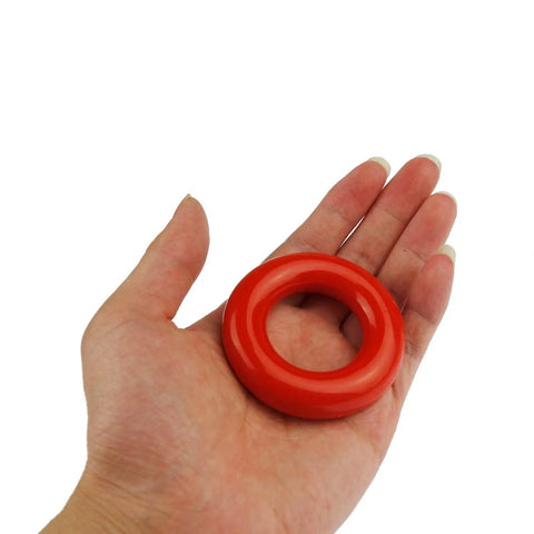 Hand holding one of the Two Pack Golf Swing Weight Rings For Warm Up, 5 Ounces Each, Rubber Coated Metal Rings That Will Not Scratch Your Clubs