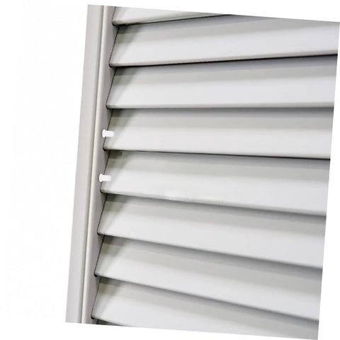 Close-up of Heavy Duty White Plastic Shutter Repair Pins And Louver Spring Clips for quick household fix ups on white louvers.