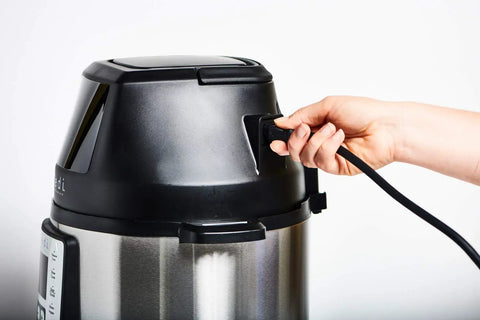 Smart air fryer lid with a hand plugging in, compatible with 6 quart electric pressure pots to enhance your cooking.
