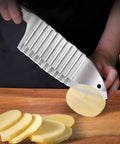 Hong Won crinkle-cut knife side view; stainless steel potato and vegetable cutter slicing potatoes on wooden board