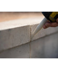Heavy Hitter Polyurethane Sealant For Exterior Surfaces Like Concrete Brick Metal Wood With No Sweat Application And Bulletproof Flexibility In White 10 Oz Tube applied between concrete bricks.