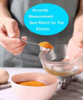 Person using 7 piece stainless steel spoon from 20 Piece Measuring Cups And Spoons Set For Cooking And Baking Gadgets in kitchen