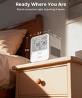 Compact Digital Radon Detector For Homes With Real Time Visual And Audio Alerts on a wooden nightstand measuring 3.2" x 3.0" x 3.8".