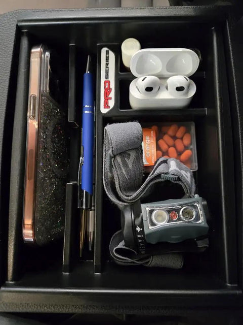 Toyota Tacoma Center Console Organizer Tray For 2024-2026 Models holding phone, earbuds, pen, vitamins, and flashlight.