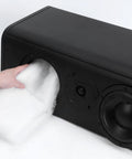 Person inserting Oversized Heavy Weight Polyester Fiber Speaker Damping Fill Sheet into a subwoofer cabinet for acoustic stuffing.