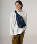 Person wearing a blue Packable Small Crossbody Sling Backpack For Travel And Hiking Ultralight Water Resistant Daypack on chest