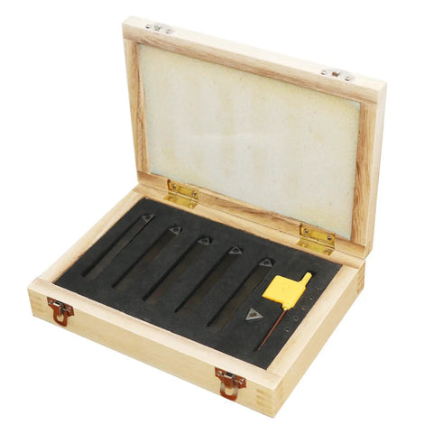 Open wooden box with five sets of one quarter inch carbide lathe tool bits for indexable turning metal lathe tools neatly arranged inside.