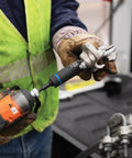 Worker uses All In One Impact Socket With Three Quarter Inch And Nine Sixteenth Inch Hex Sizing Deep Twelve Point Socket One Half Inch Drive High Torque Design For Easy Pole Hardware Installations And Hard To Reach Fasteners with impact driver