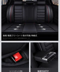 Backseat of a car showing black leather upholstery with red stitching, featuring a central armrest and seatbelt buckle.