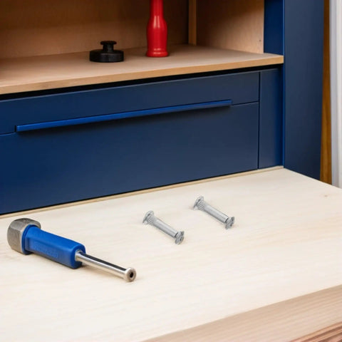 Two Rock Solid 100 Piece Pack M6 Cabinet Panel Binding Bolts made from cold rolled steel on a wooden surface with a tool.