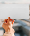 Hand holding a White Self Seal Confidentiality Envelopes 115mm By 225mm For Office Documents And Shipping.