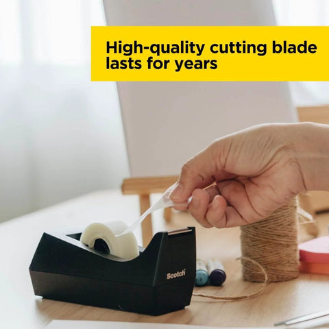 Hand using Desktop Tape Dispenser, Black Polystyrene, Weighted Base, One-Hand Dispensing, Refillable 1-in Core Fits 0.75 in Tape