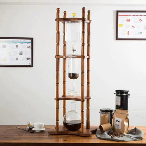 Premium Gravity Fed Cold Brew Coffee Maker With Slow Drip Ice Tower And Zero Fuss Borosilicate Glass Carafe on wooden stand.