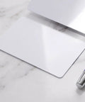 Heavy Duty 50 Piece Set Blank White Pvc Id Cards Dual Sided Printable With Smart Chip Access on marble surface, with pen.
