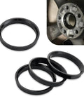 Set Of Four Black Wheel Hub Center Rings With 2.87 Inch Od And 2.36 Inch Id Plastic Adapters displayed on wheel for installation.