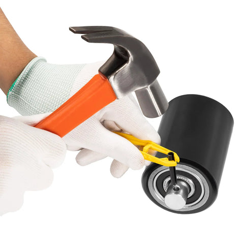 Hands using tools to install bearings on Front Load Pallet Jack Wheels Replacement Kit for PTH50, Pair Front Load Rollers.