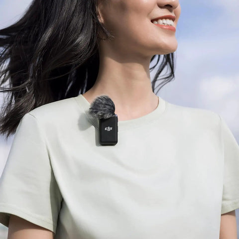 Person wearing wireless lavalier microphone system with two transmitters and one receiver for interviews YouTube vlogs live streams