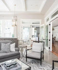 Modern living room featuring gray sofa, stylish chairs, and natural light, showcasing the Real Deal Reclaimed Rustic Wood Stain Providing A Hella Smooth Water Based Finish That Reacts Naturally With Tannins To Create An Authentic Weathered Look Perfect For Interior Or Exterior Makeovers In A Convenient 55 Gallon Barrel.