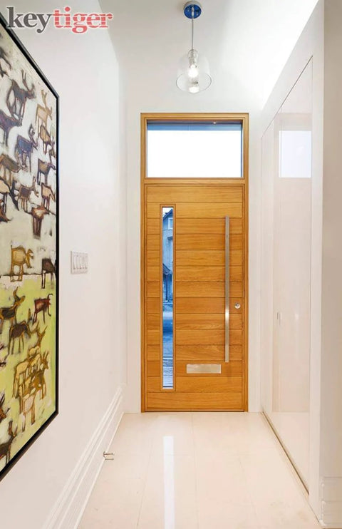 Front view of a wooden door with 32 Inch Two Sided Stainless Steel Modern Entry Door Handles Matte Black Painted Finish External Internal Pull Push Bar For Single Or Double Doors Sliding Barn Door Hardware Rectangle Flat Bar installed in a minimalist hallway.