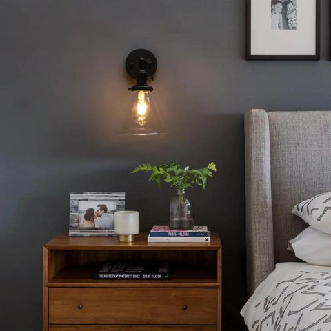 Hardwired Wall Sconce With Switch For Indoor Lighting above wooden nightstand with books and decor in bedroom