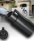 Top Tier Nacs To J1772 Ev Charging Adapter With 80 Amp Max And 250 Volt Rating, close-up of black charging plug outdoors.