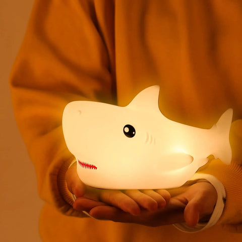 Rechargeable Cute Squishy Shark Night Light For Kids And Teens Soft Silicone Touch Lamp With Gentle Glow held in hands