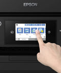 Hand pointing at touchscreen of Wireless Color All In One Inkjet Printer With PrecisionCore Heat Free Tech And Instant Dry Pigment Ink.
