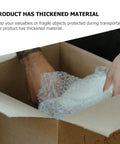 Person packing with thickened LDPE bubble wrap roll for moving and shipping, double-sided cushion film for ceramics and glass protection.