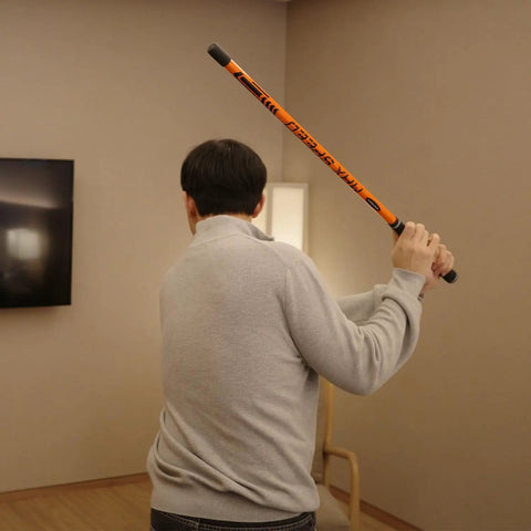 Man practicing with Golf Swing Trainer Pro Indoor Practice Aid With MAX SPEED Stick and Speed Pointer at home