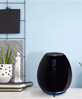 Compact Small Room HEPA Type Air Purifier With 360 Degree Intake For Up To 112 Sq Ft Black Finish on table in modern room