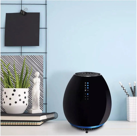 Compact Small Room HEPA Type Air Purifier With 360 Degree Intake For Up To 112 Sq Ft Black Finish on table in modern room