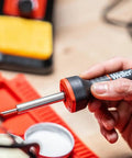 Hand holding 5 To 30 Watt Precision Soldering Iron Station With Adjustable Wattage And Integrated Safety Rest In Compact 120V Design