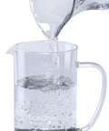 Dorothy Electric Rapid Cold Brewer pitcher with water being poured, showcasing use for home coffee making with Tornado Stir Technology.