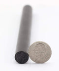 Extra Large Half Inch By Six Inch Ferro Rod Survival Fire Starter Ferrocerium With Drilled Lanyard Hole next to a coin