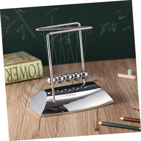 Z Shape Newton Cradle Pendulum Desk Toy For Home Office Decor with five silver balls on a wooden table, educational model.