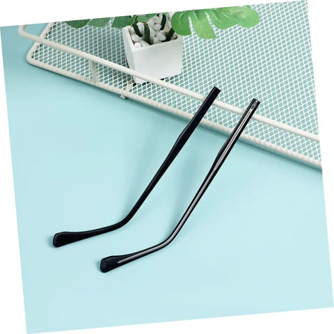 Two Pairs Metal Eyeglass Arms Replacement Kit With Black Temple Legs For Quick Fixes, no glasses, on blue surface