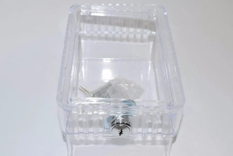 G10 Universal Locking Thermostat Guard With Key, clear plastic cover shown from above, displaying lock mechanism and transparent material