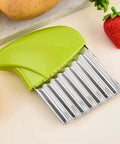 Green-handled stainless steel crinkle cutter with a wavy blade for vegetables