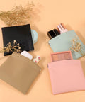 Four Pack Small Makeup Bags For Purse And Travel in Morandi tones with cosmetics and floral accents on display.