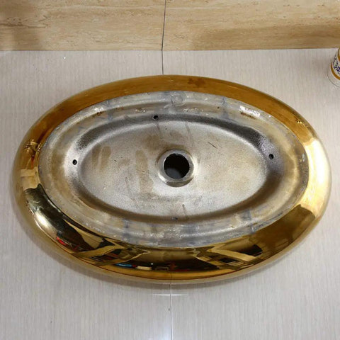 Top view of the heavy duty ceramic vessel sink for modern bathrooms with included faucet dope gold oval basin.
