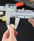 Pro Grade Six Inch Stainless Steel Caliper for Inside Outside Depth and Step Measurements in use measuring coin