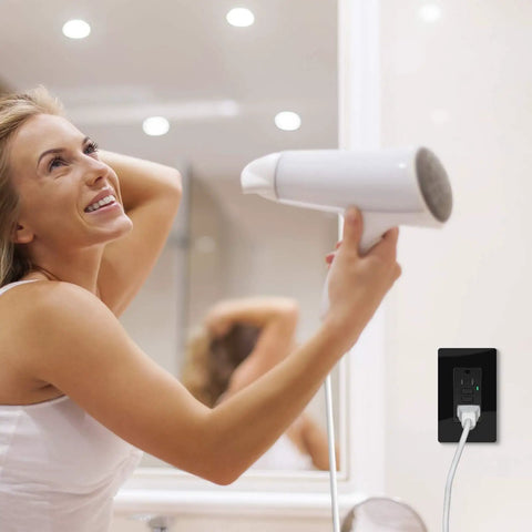 Woman using hair dryer plugged into Black GFCI Outlet 15 Amp Weather Resistant Electrical Receptacle With Decorator Screwless Plate ETL