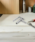 Stainless Steel Double Swing Door Hinges With Self-Closing Spring Load for 16mm-20mm Doors, shown with tools on workbench.